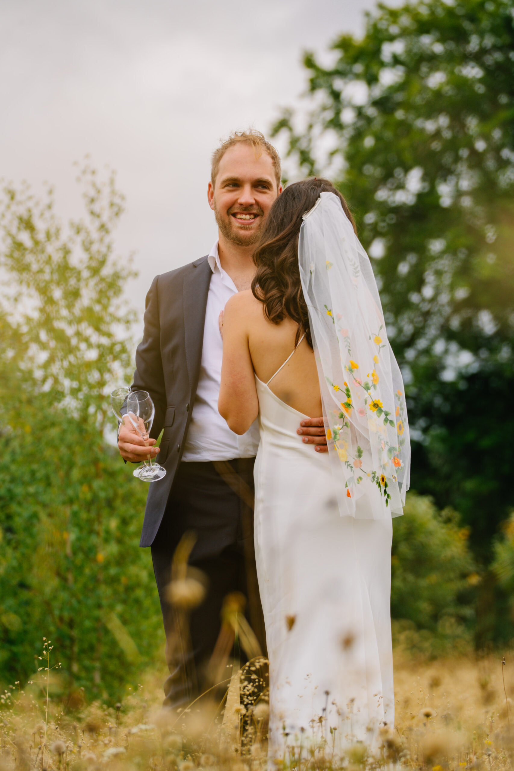 Bride and groom sharing a quiet moment with a glass of fizz, part of my Bedhampton wedding photographer prices and packages