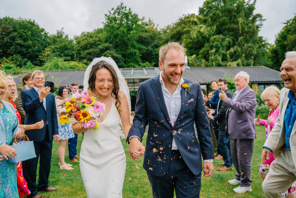 The couple laughing as they leave their outdoor ceremony, featured in our guide to Ceremony Only Wedding Photography