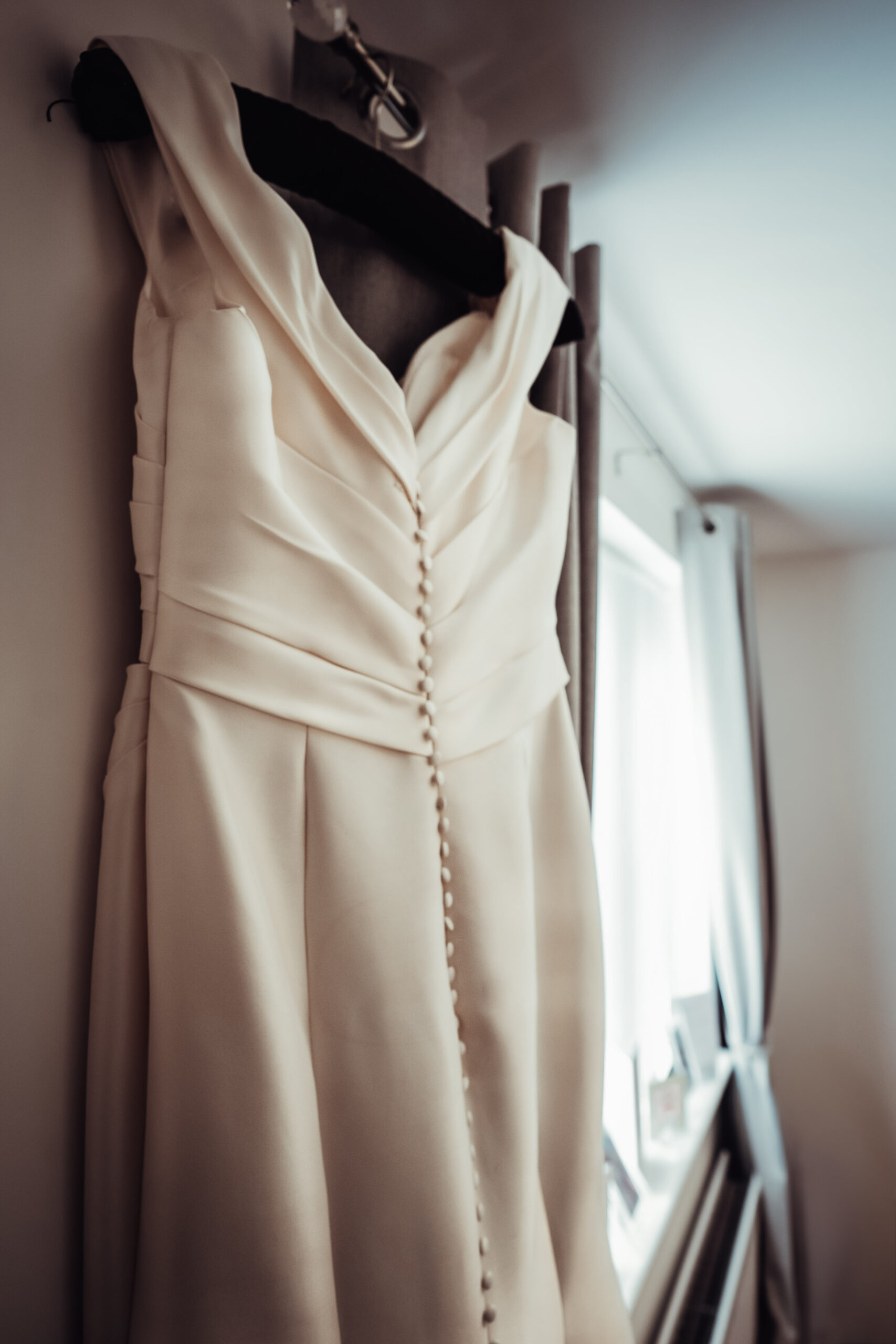 Close-up of the buttons on the back of a wedding dress, part of a set of getting ready wedding photos