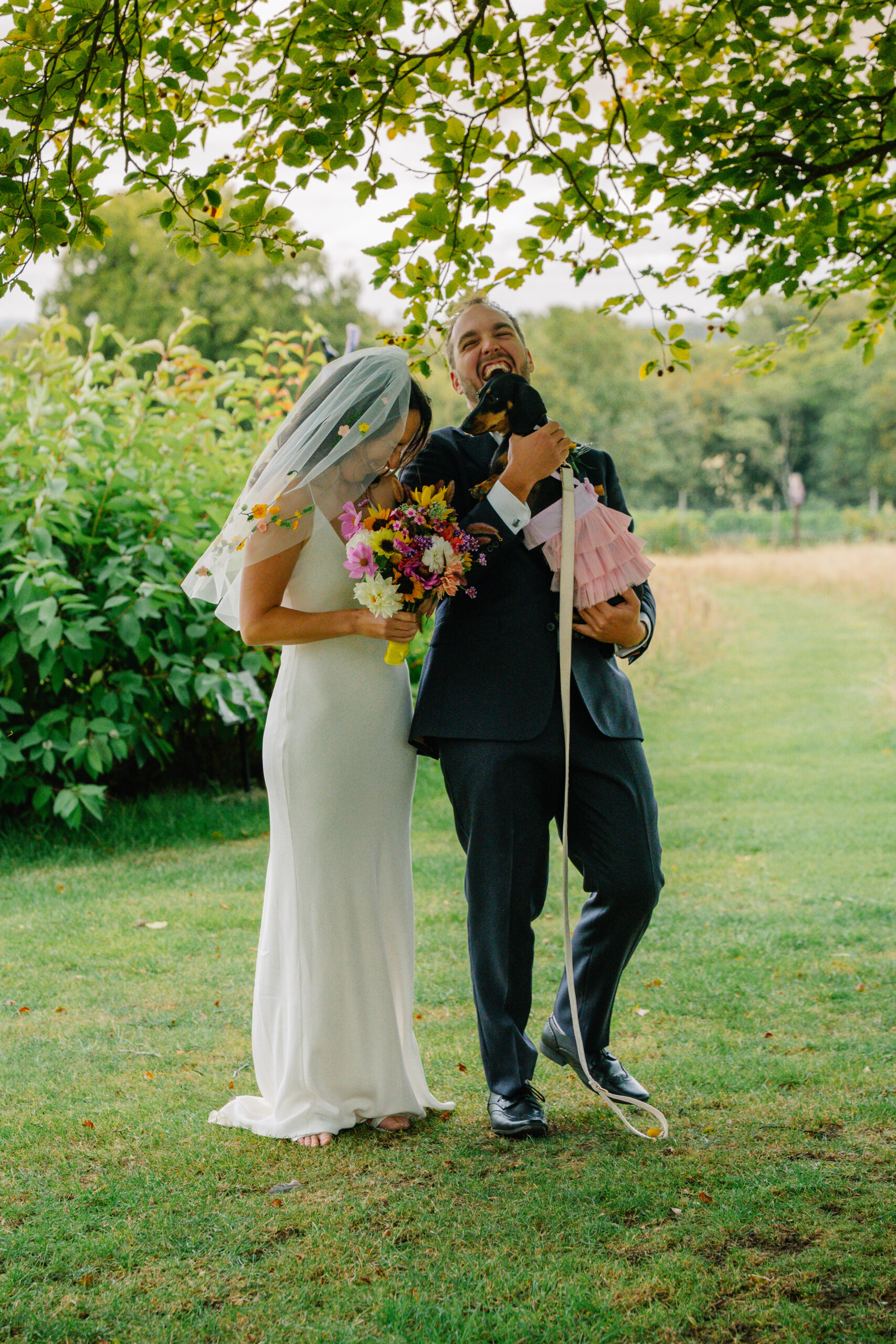Bride holding a colourful bouquet beside the groom, part of my Havant wedding photographer prices and packages