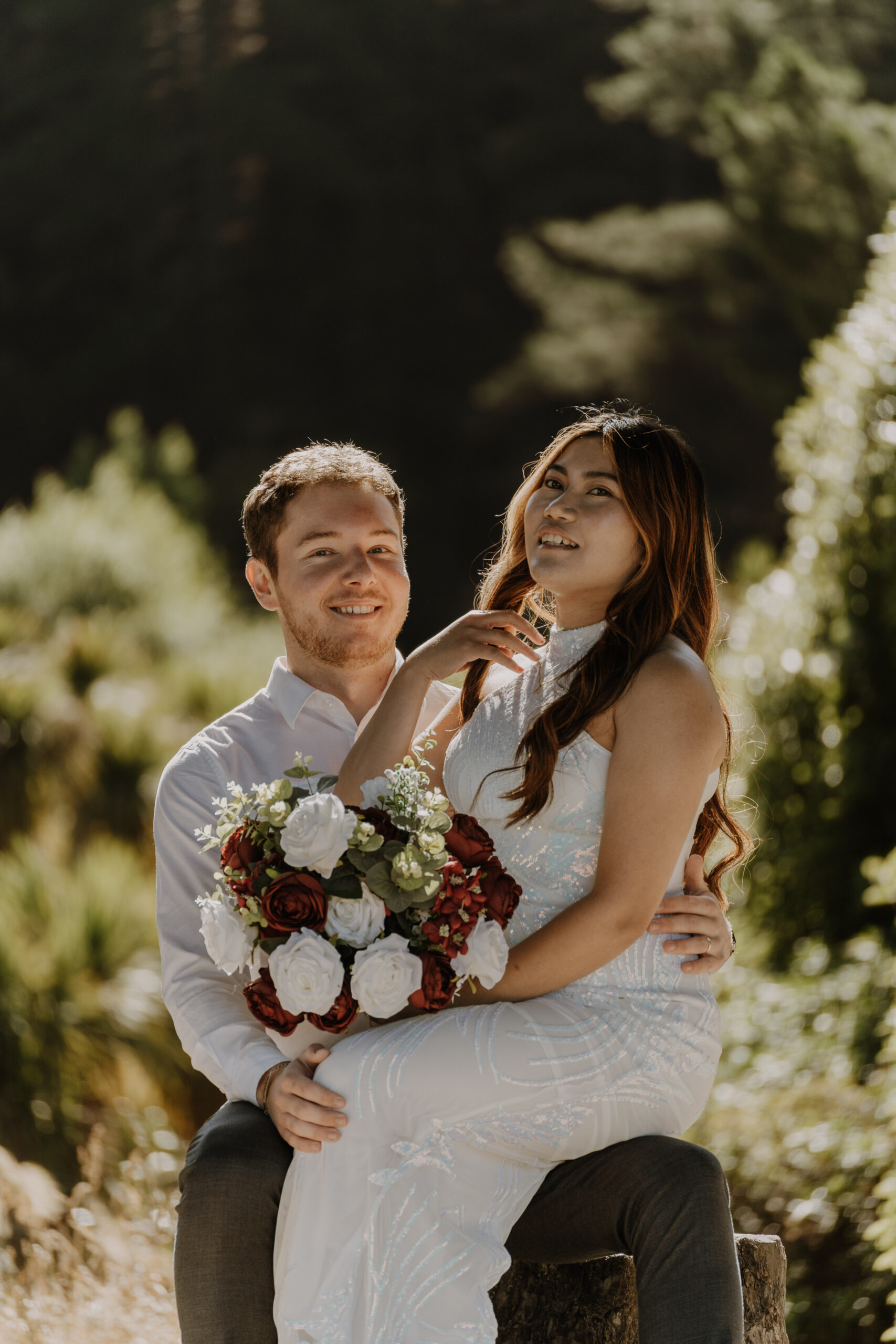 Bride and groom laughing together with her bouquet, one of my favourite natural wedding photography poses
