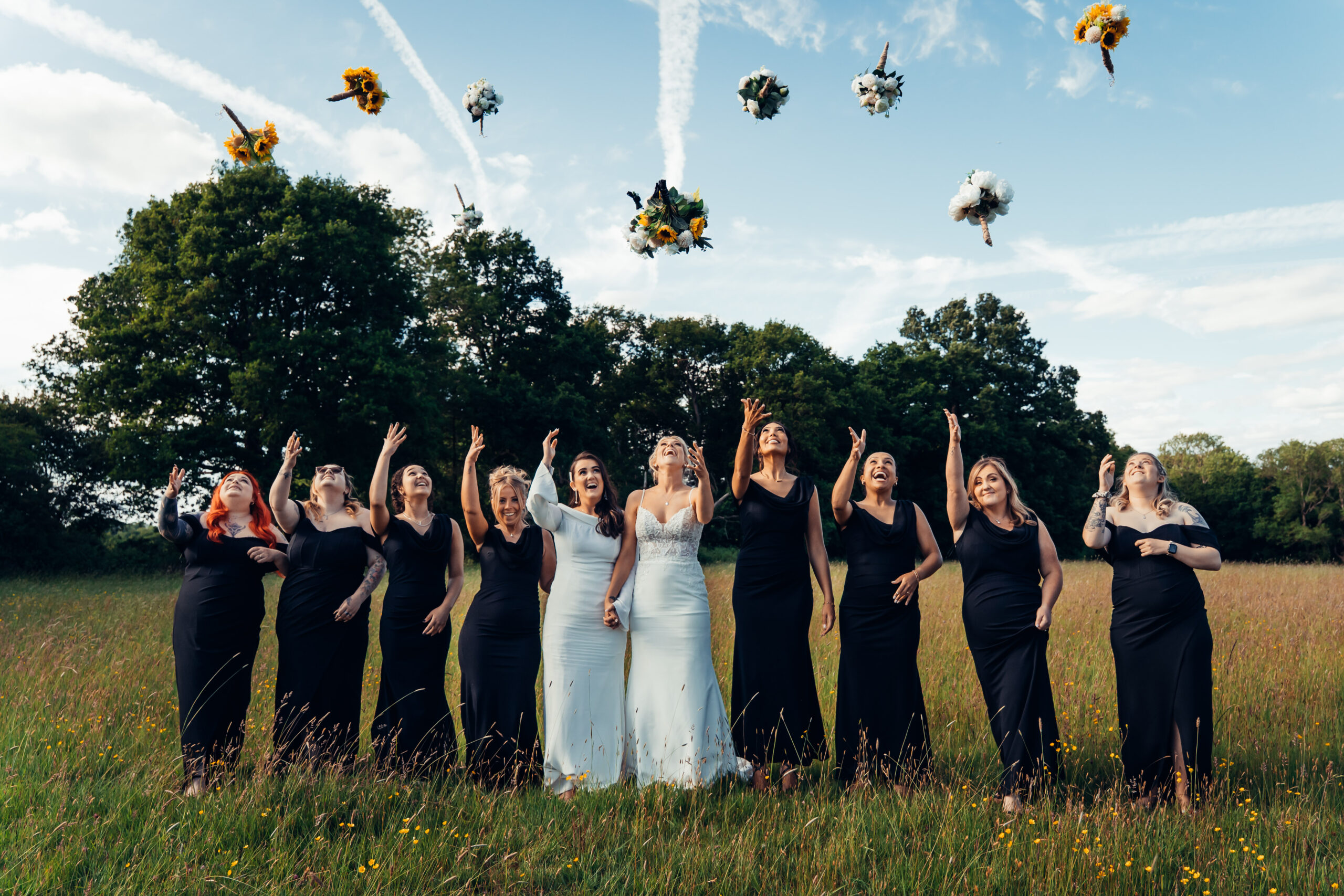 Bridal party throwing bouquets into the air, part of my Swanwick wedding photographer prices and packages