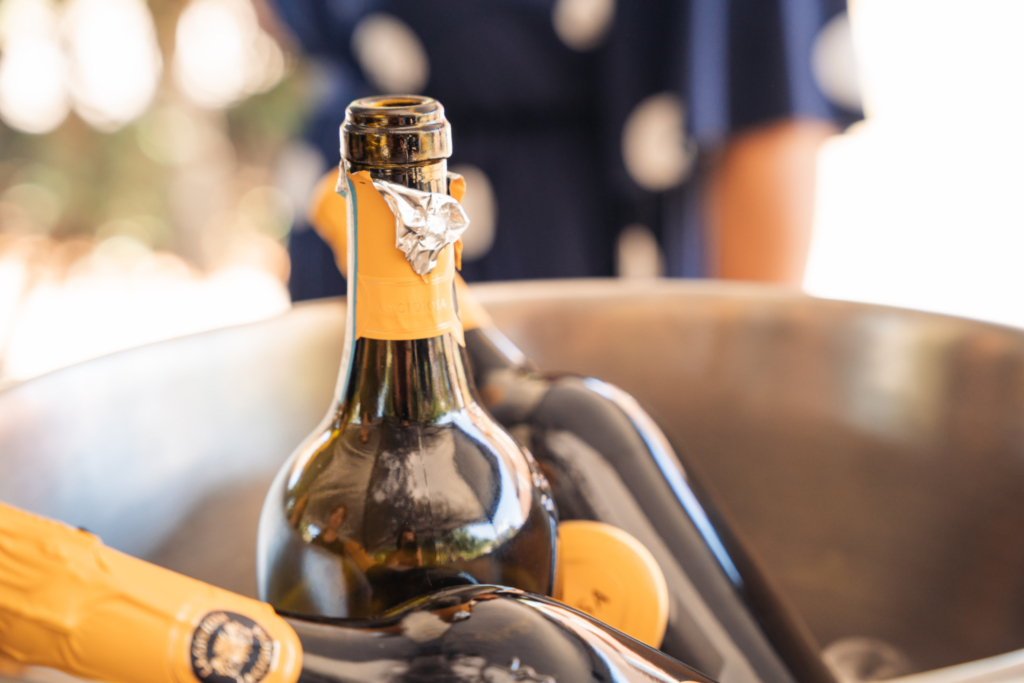 Bottle of fizz chilling in an ice bucket, phone-shot moment showing what a wedding content creator cost covers
