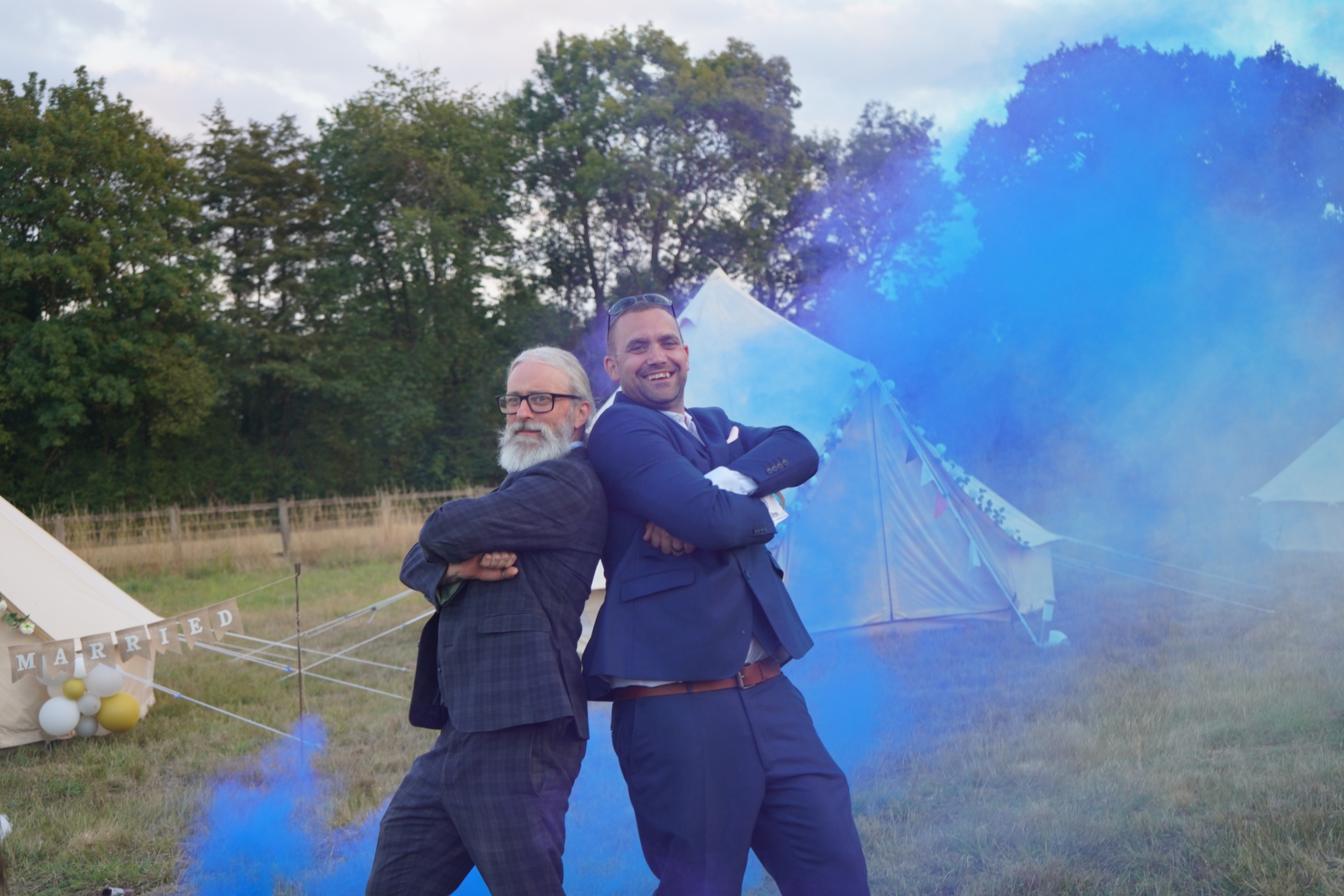 Groomsmen posing with blue smoke at a Hampshire wedding