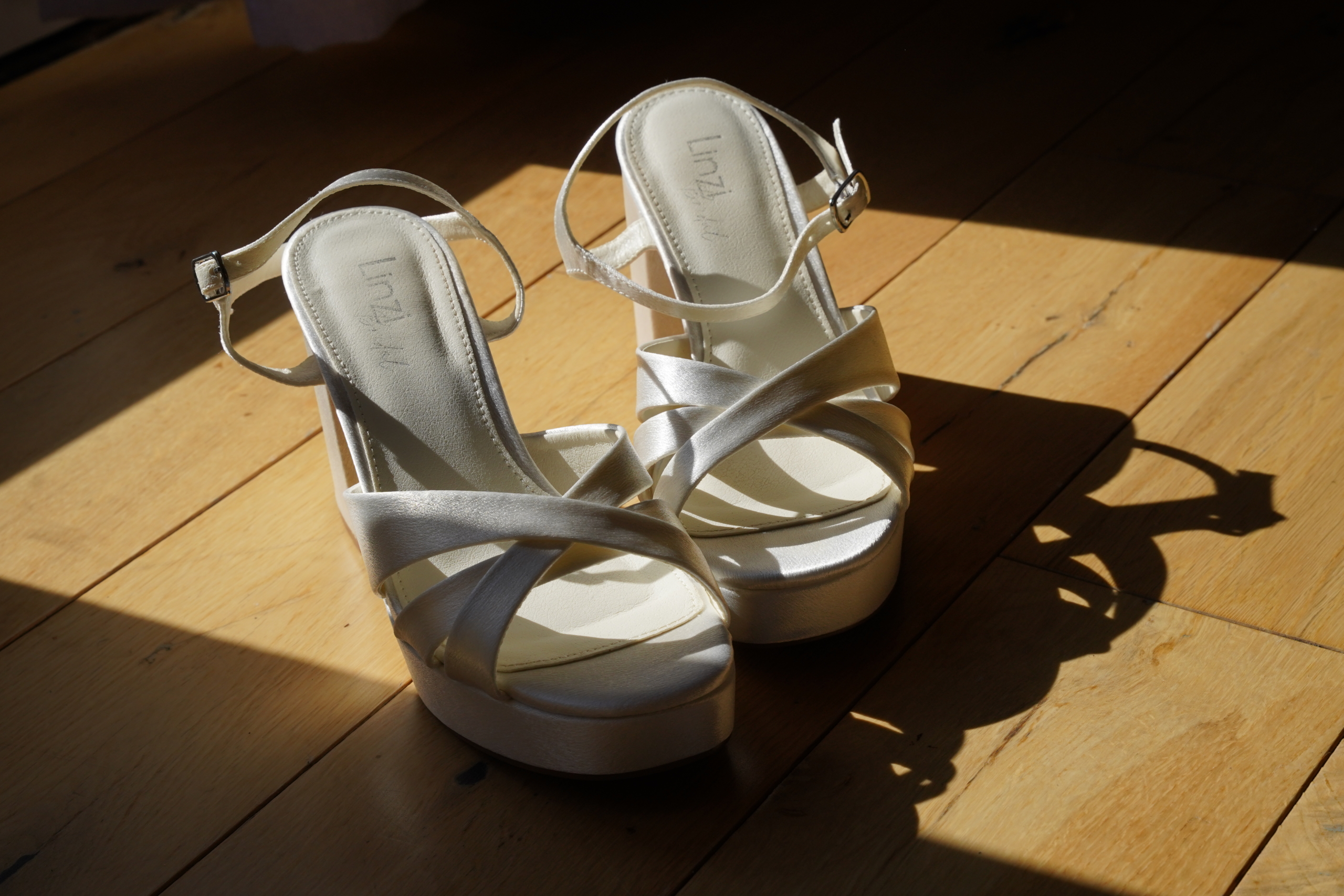 Bridal shoes on a wooden floor on a New Forest wedding morning