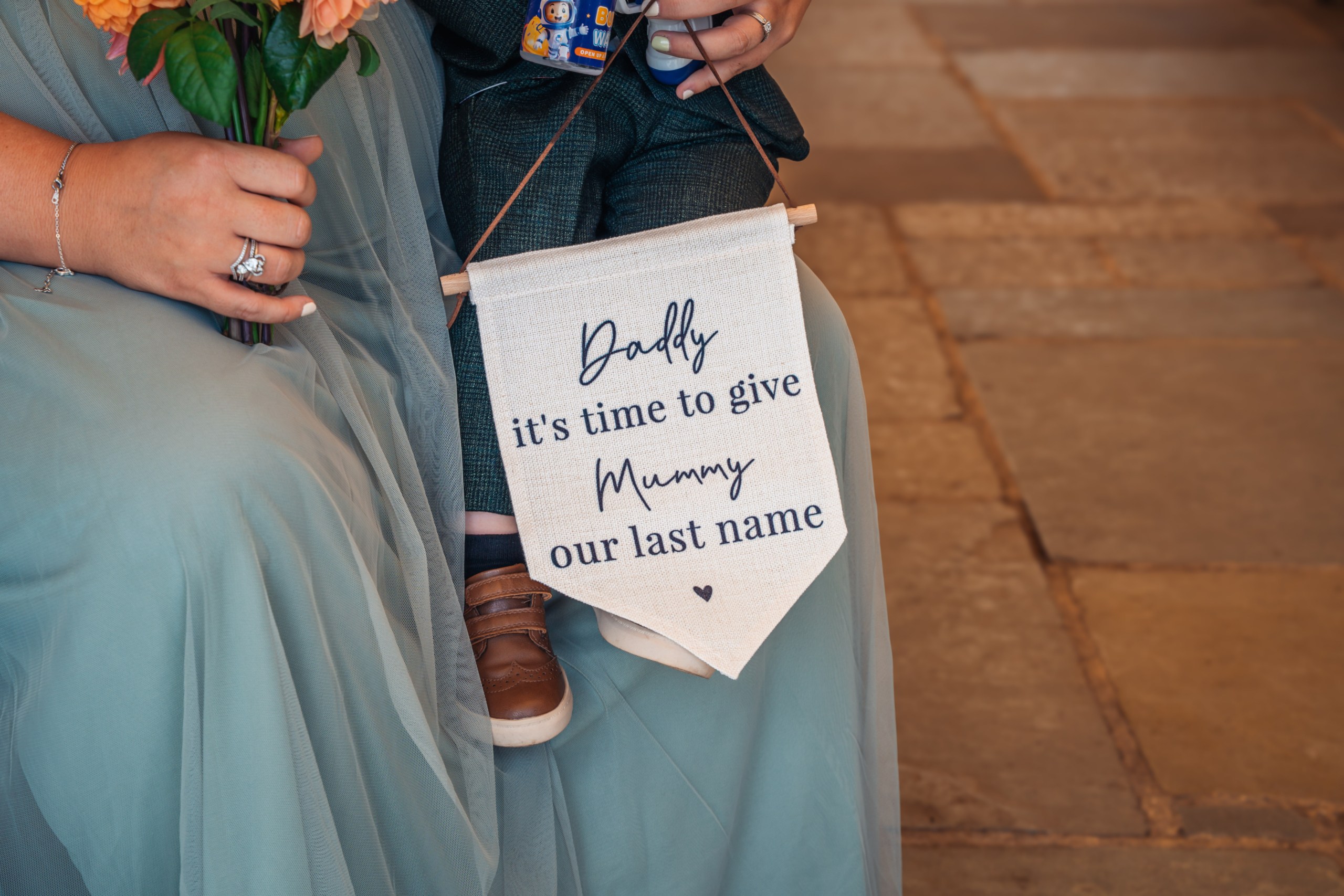 A page boy carrying a sign down the aisle at a Portsmouth wedding