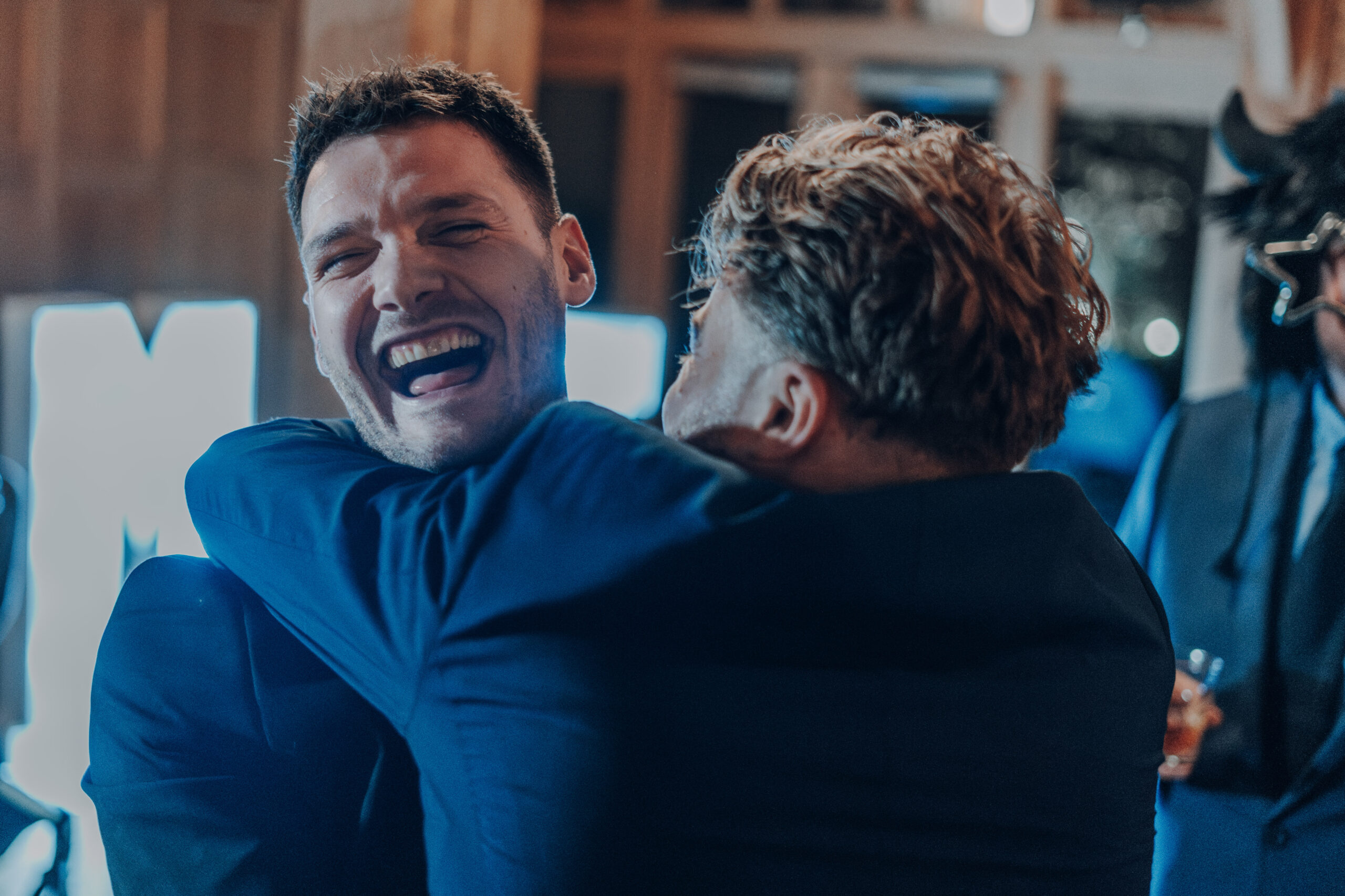 Wedding guests laughing and embracing in Portsmouth