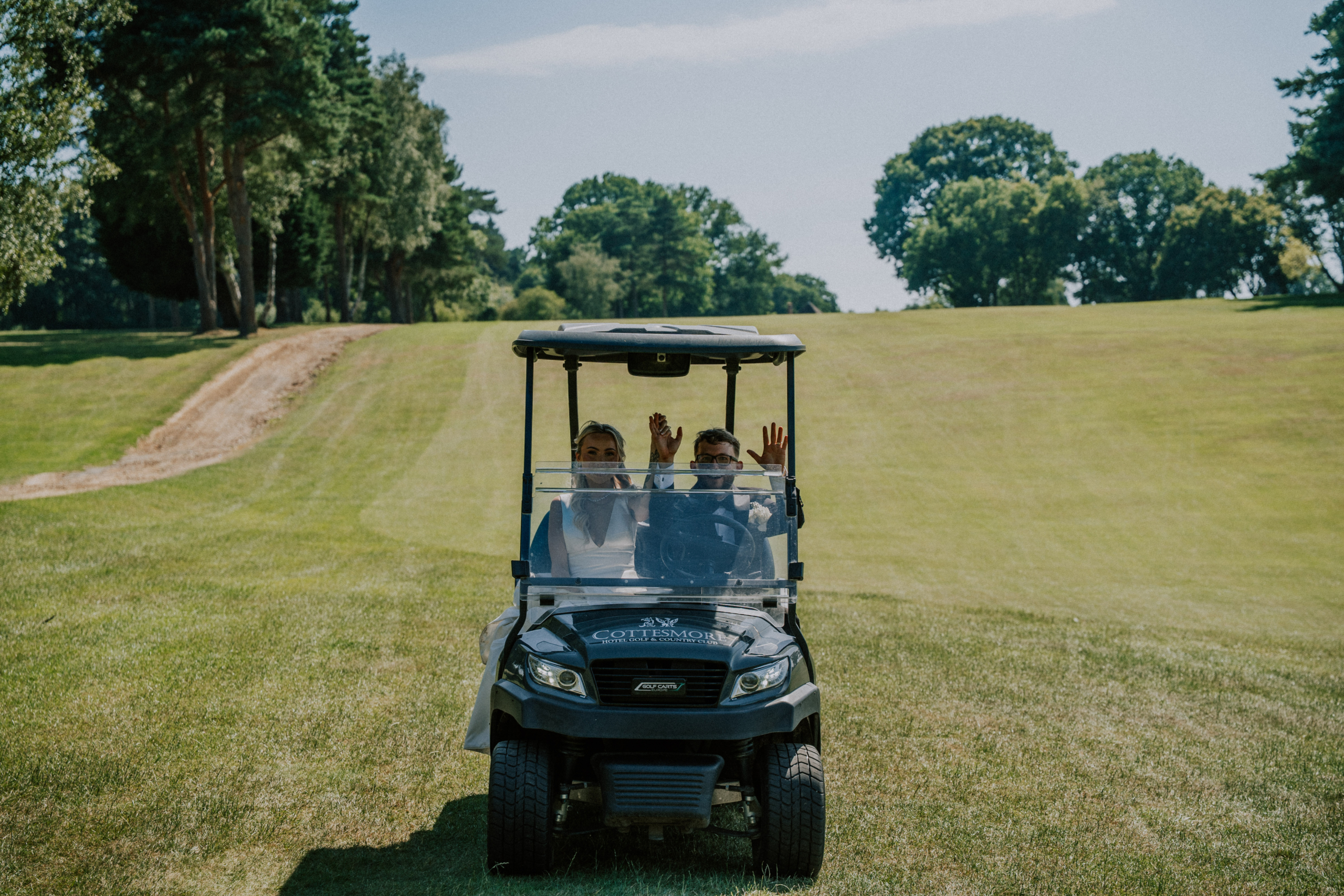 Wedding Content Creator Southampton 6 The newlyweds driving a golf buggy across the green