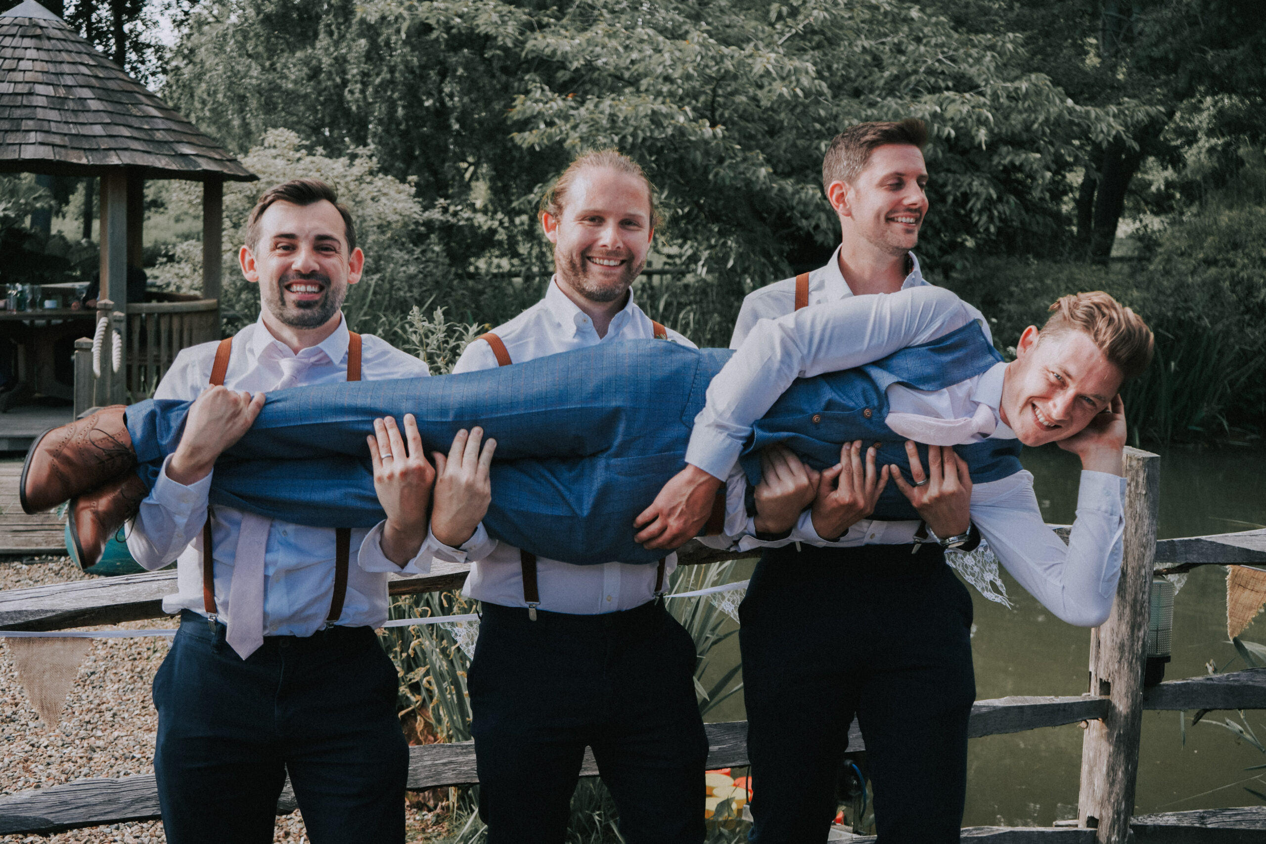 Groomsmen lifting the groom in celebration, a candid moment ideal for wedding instagram content
