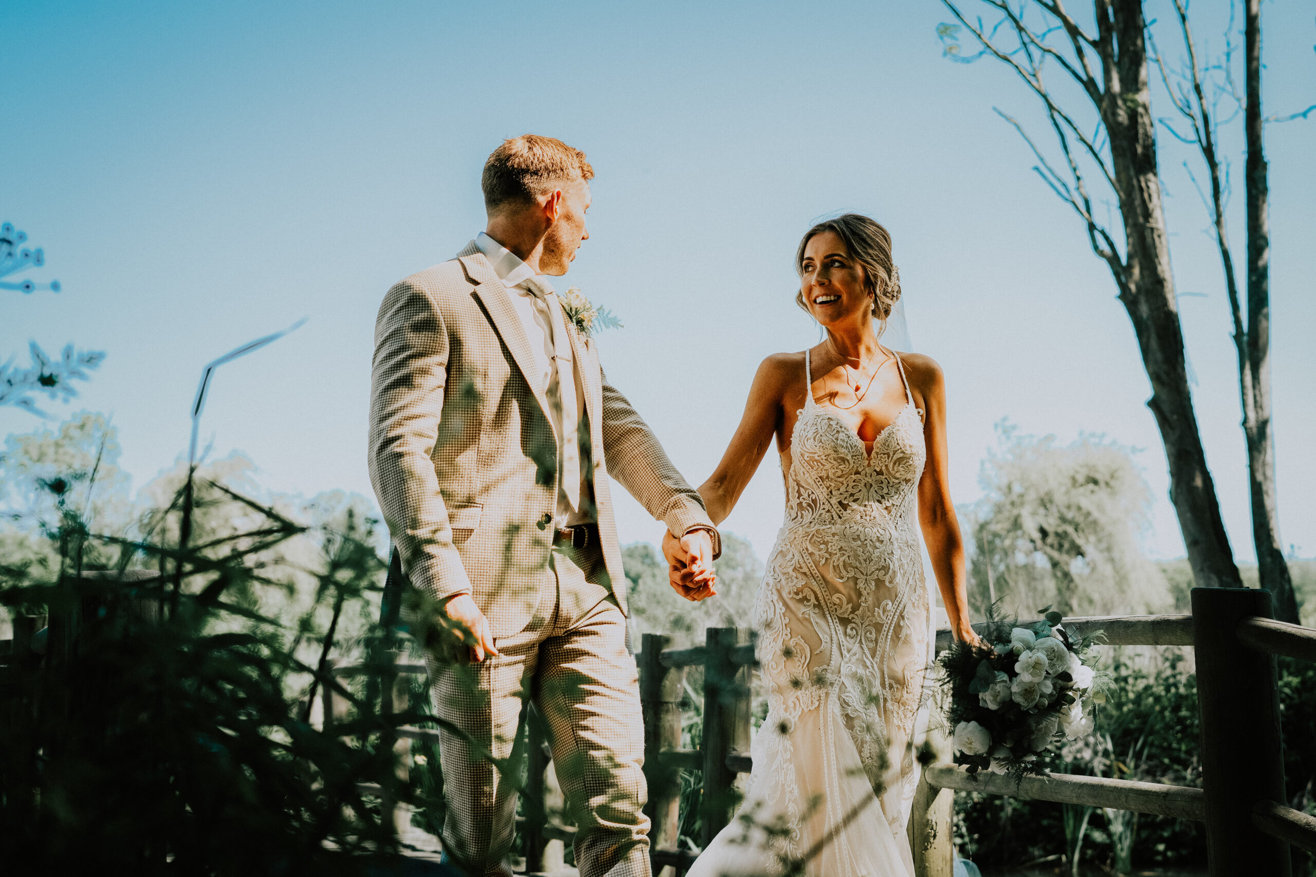 Couple walking in bright sunshine, the light you find at wedding photo spots in Southsea