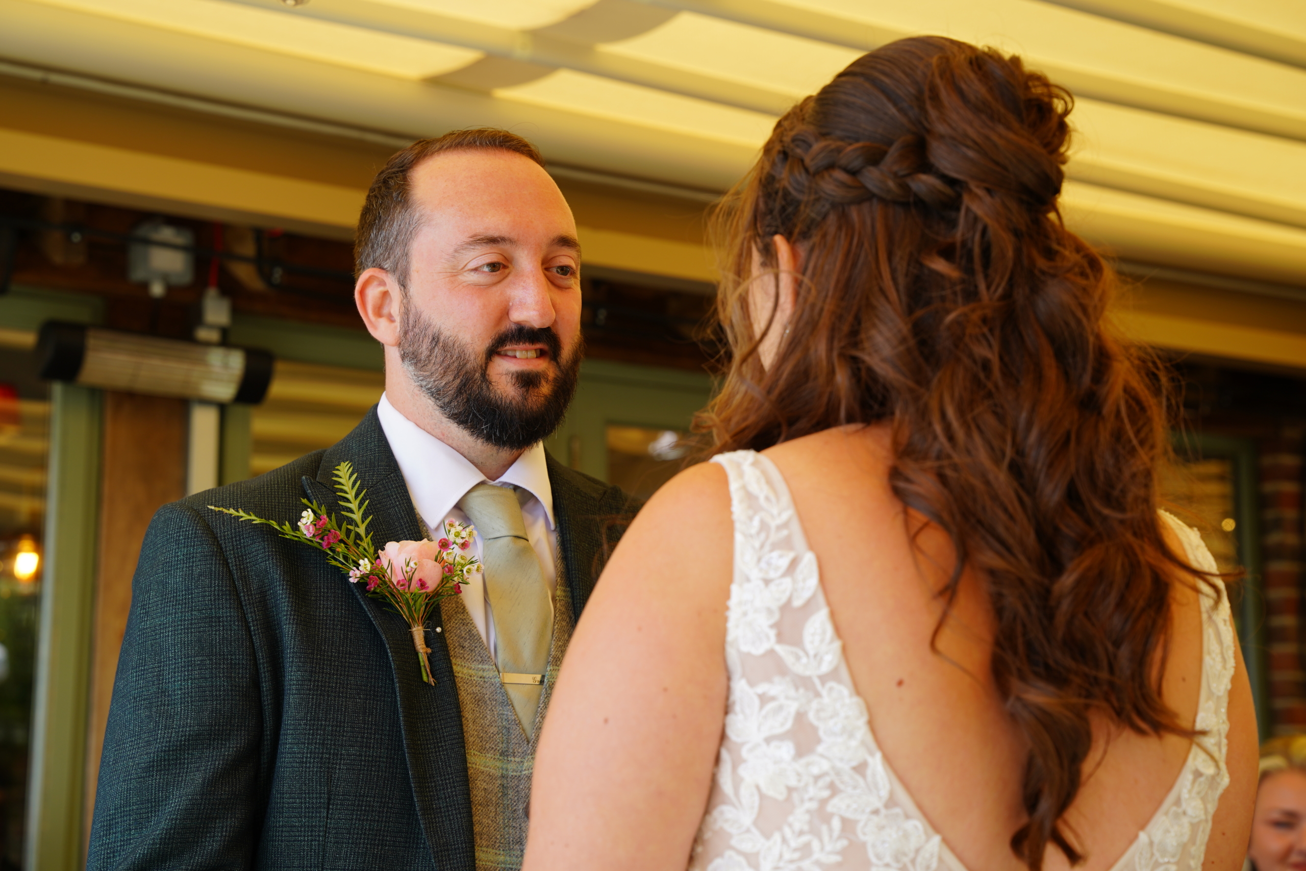 The groom gazing at his bride during the ceremony, photographed by a wedding photographer in Hampshire