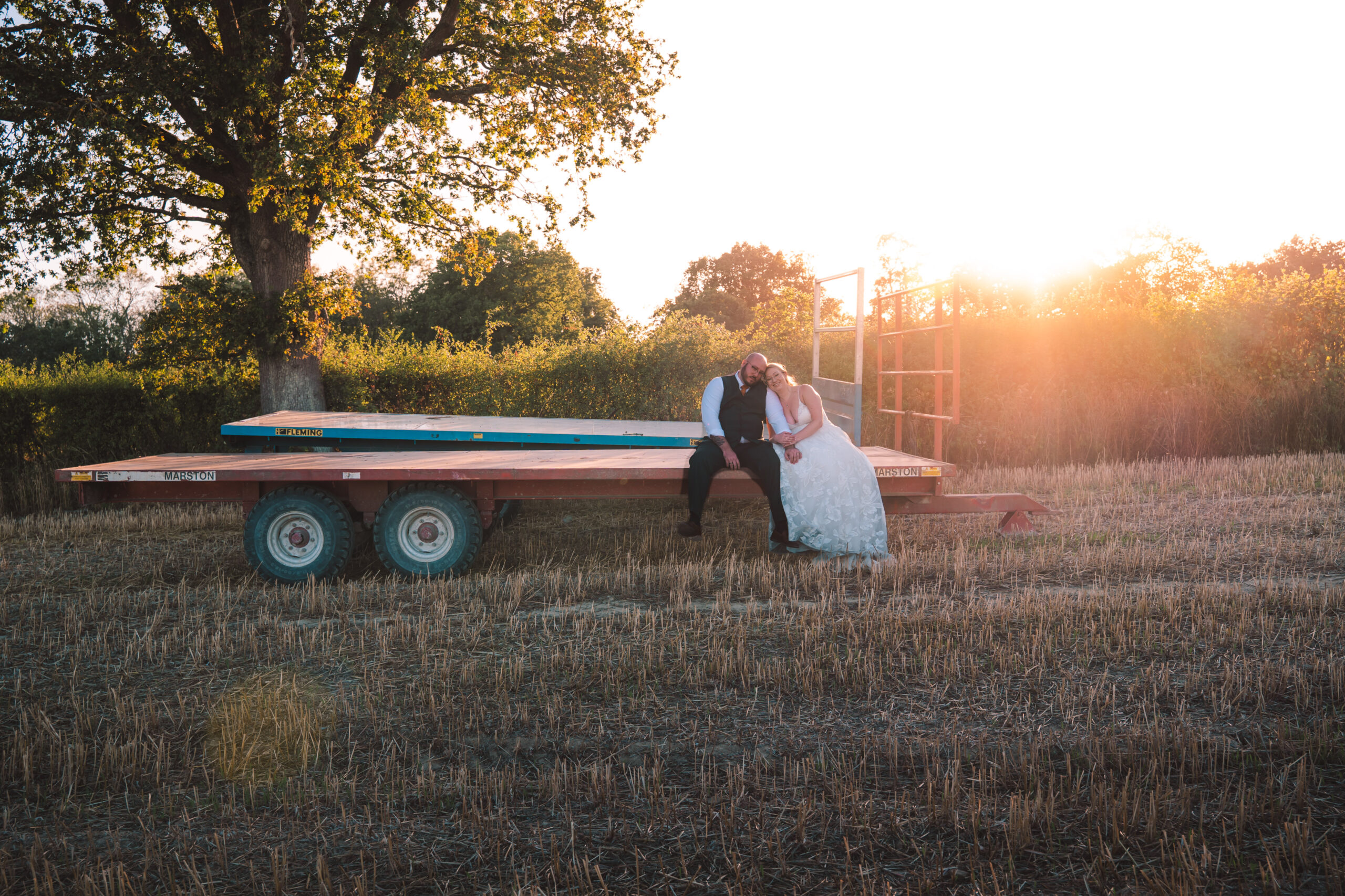 Newlyweds beside a vintage trailer at sunset, photographed by a wedding photographer in Bursledon