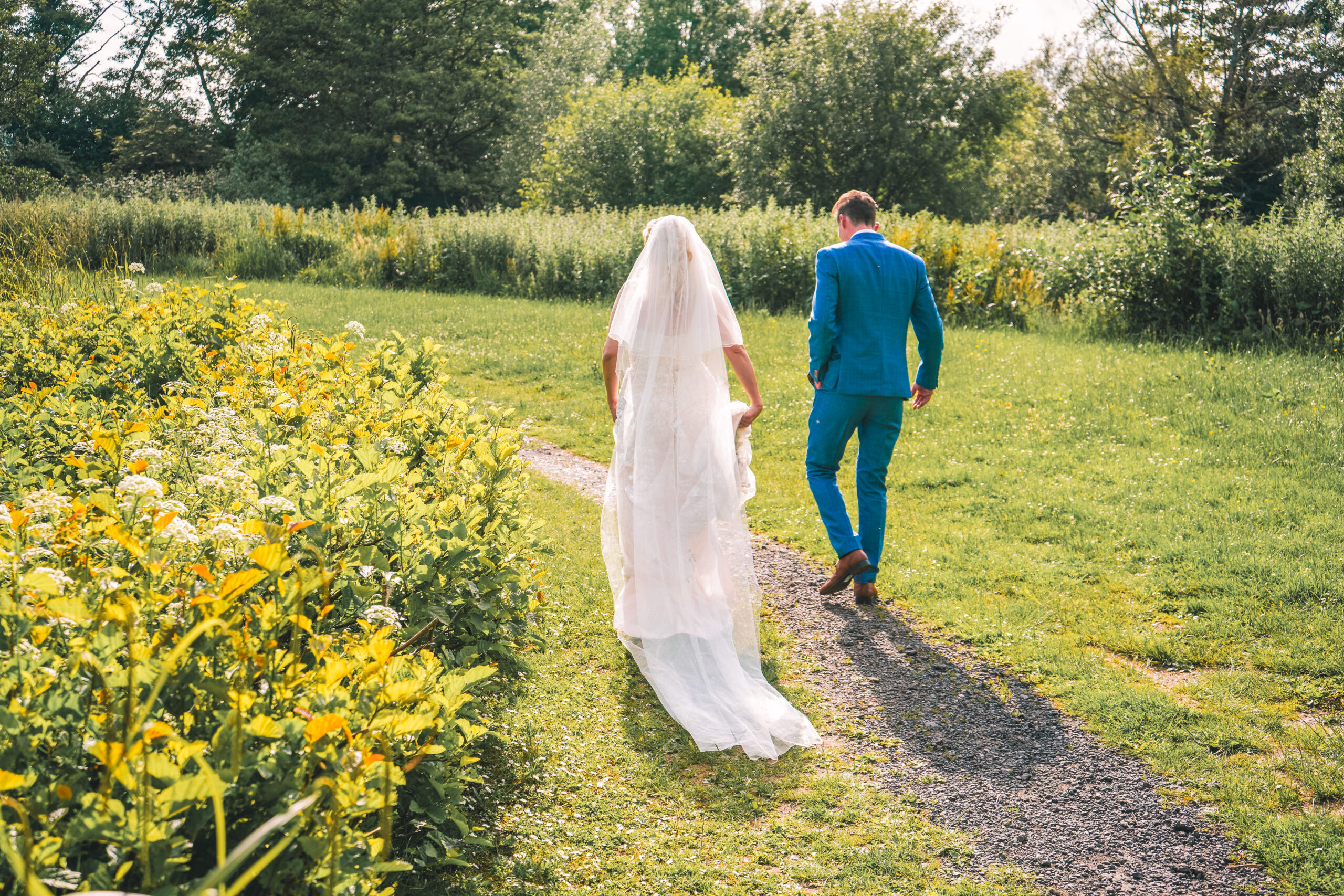 Bride and groom walking along a country path in the New Forest