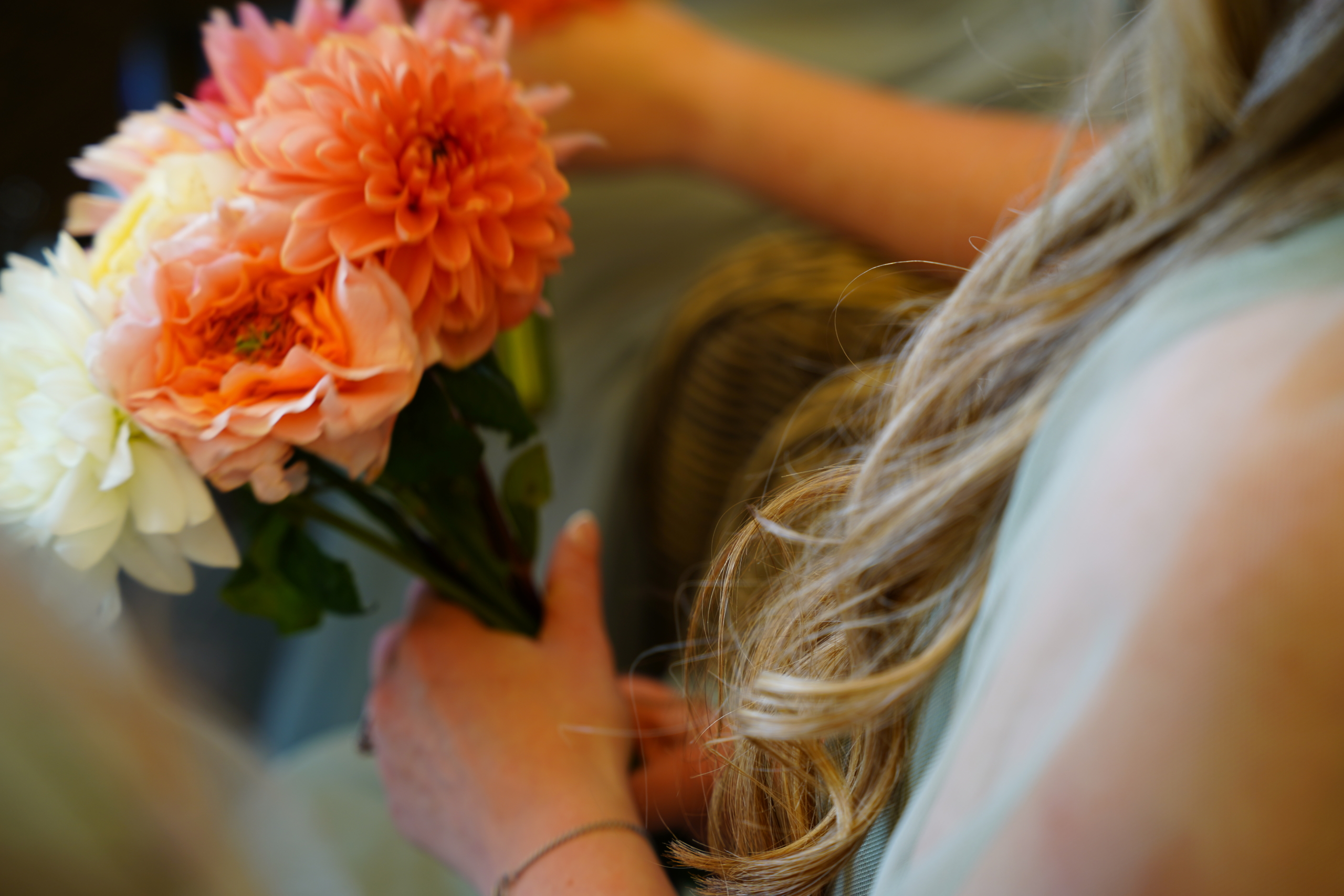 A bride holding a bright orange bouquet at a Portsmouth wedding
