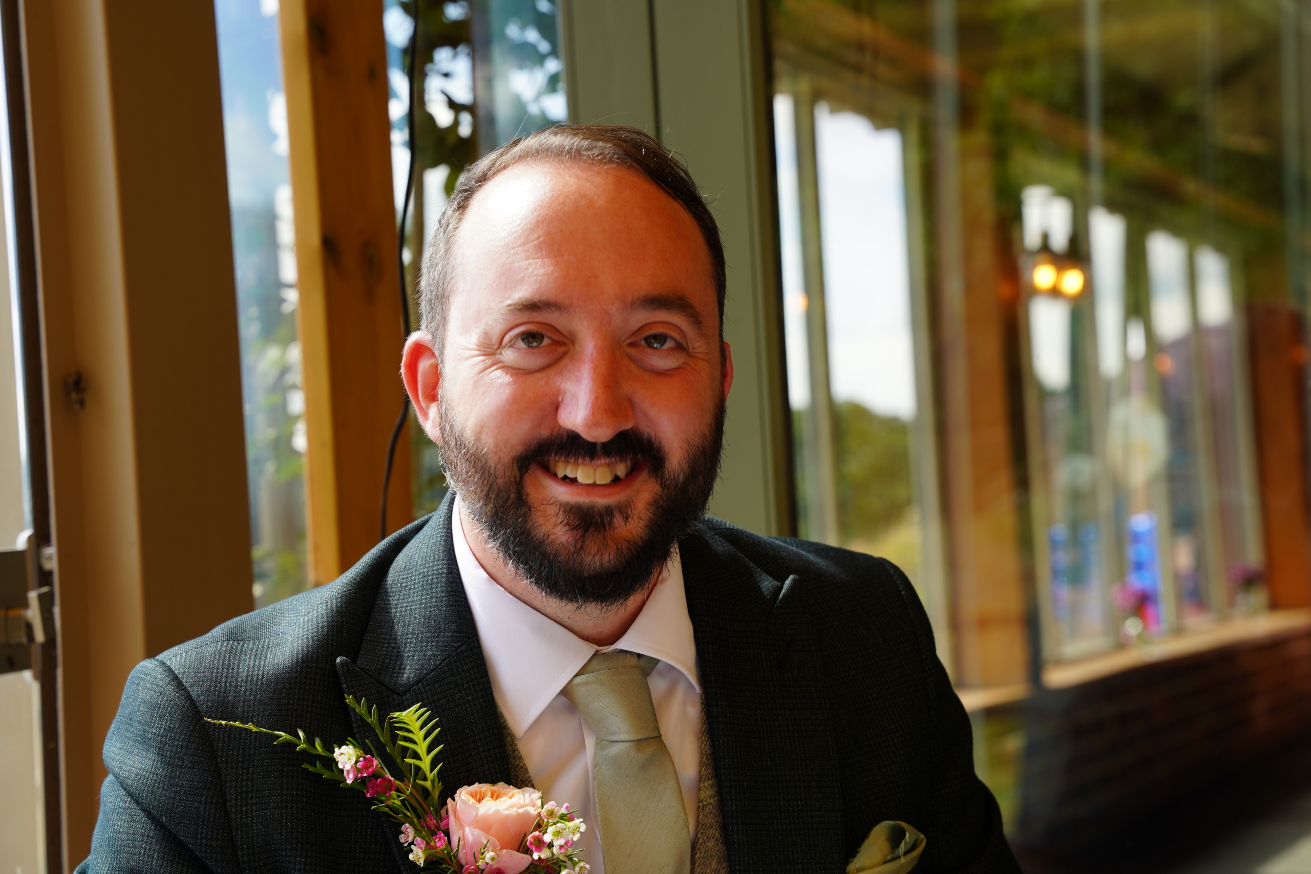 A smiling groom in his wedding suit at a Portsmouth wedding