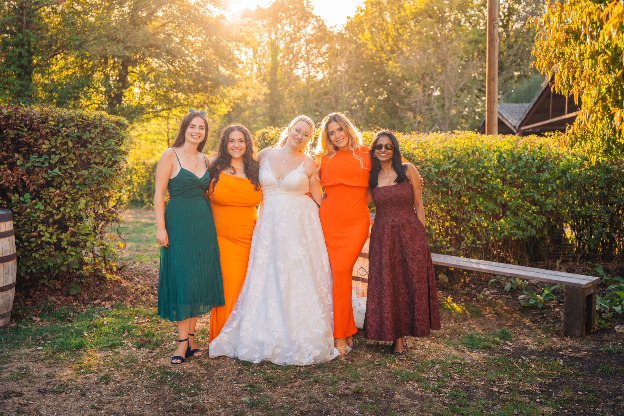 Bride and bridesmaids in golden hour light, typical of wedding venues in Fareham with open grounds