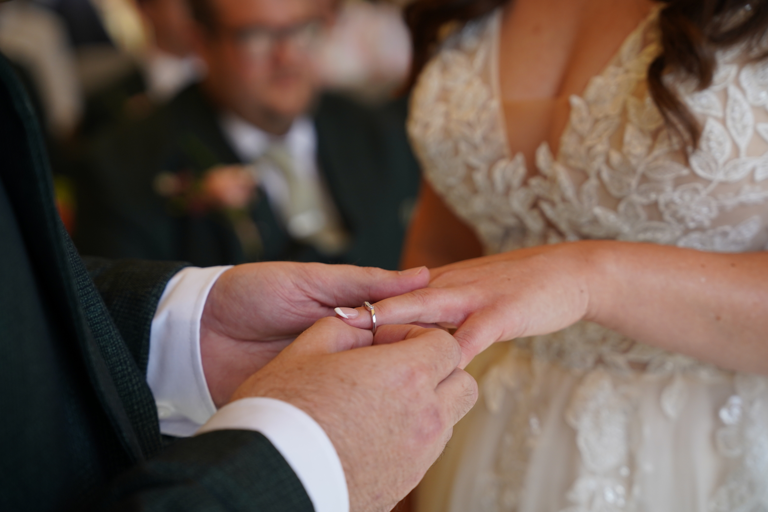 The couple exchanging rings during the vows at a Hampshire wedding