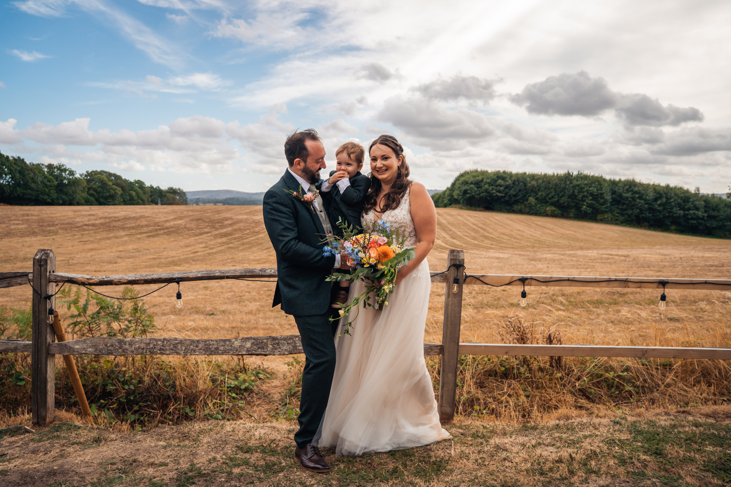 Wedding Videographer New Forest field Bride and groom standing in a golden field near the New Forest