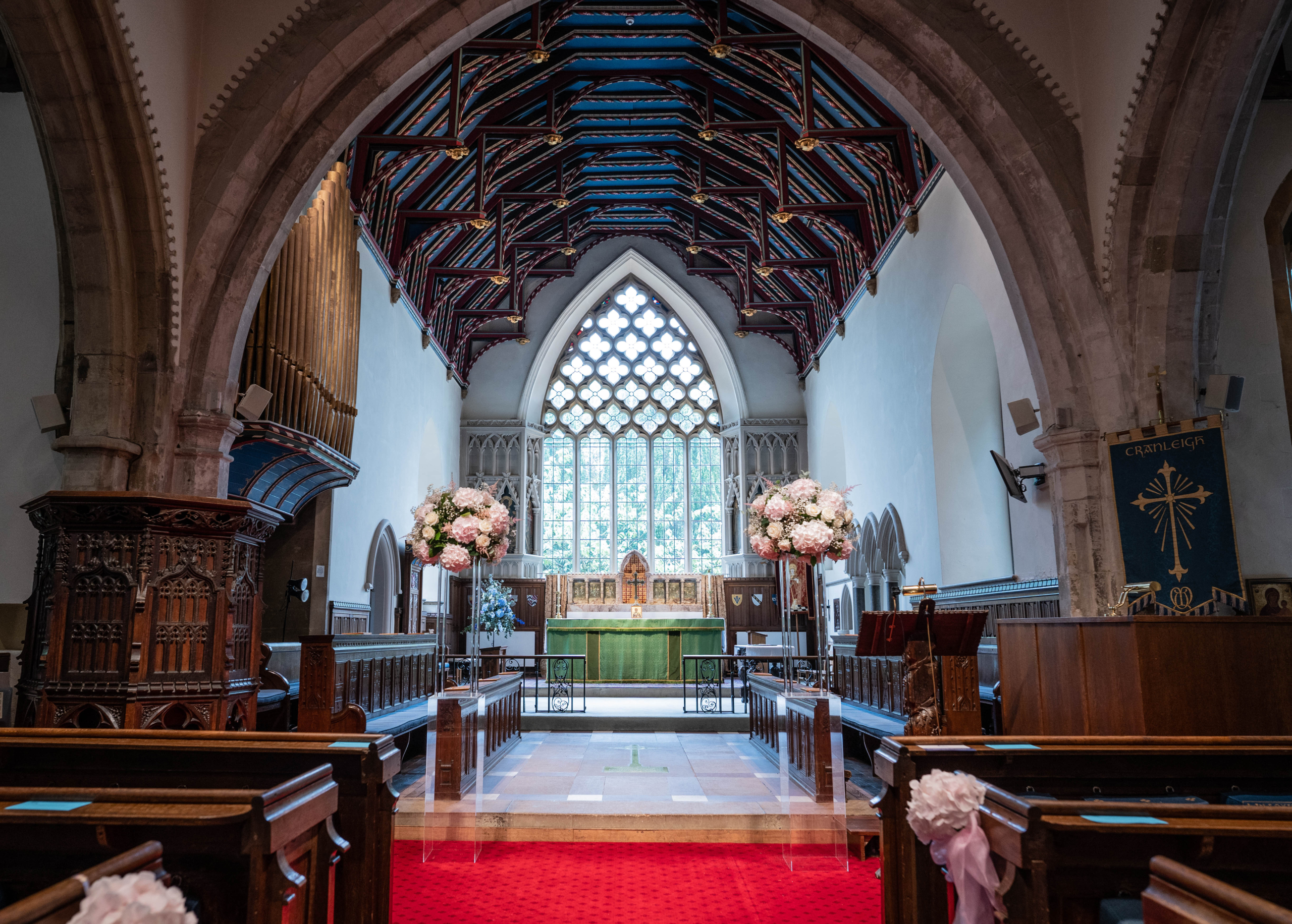 A church aisle decorated with flowers before a Portsmouth wedding