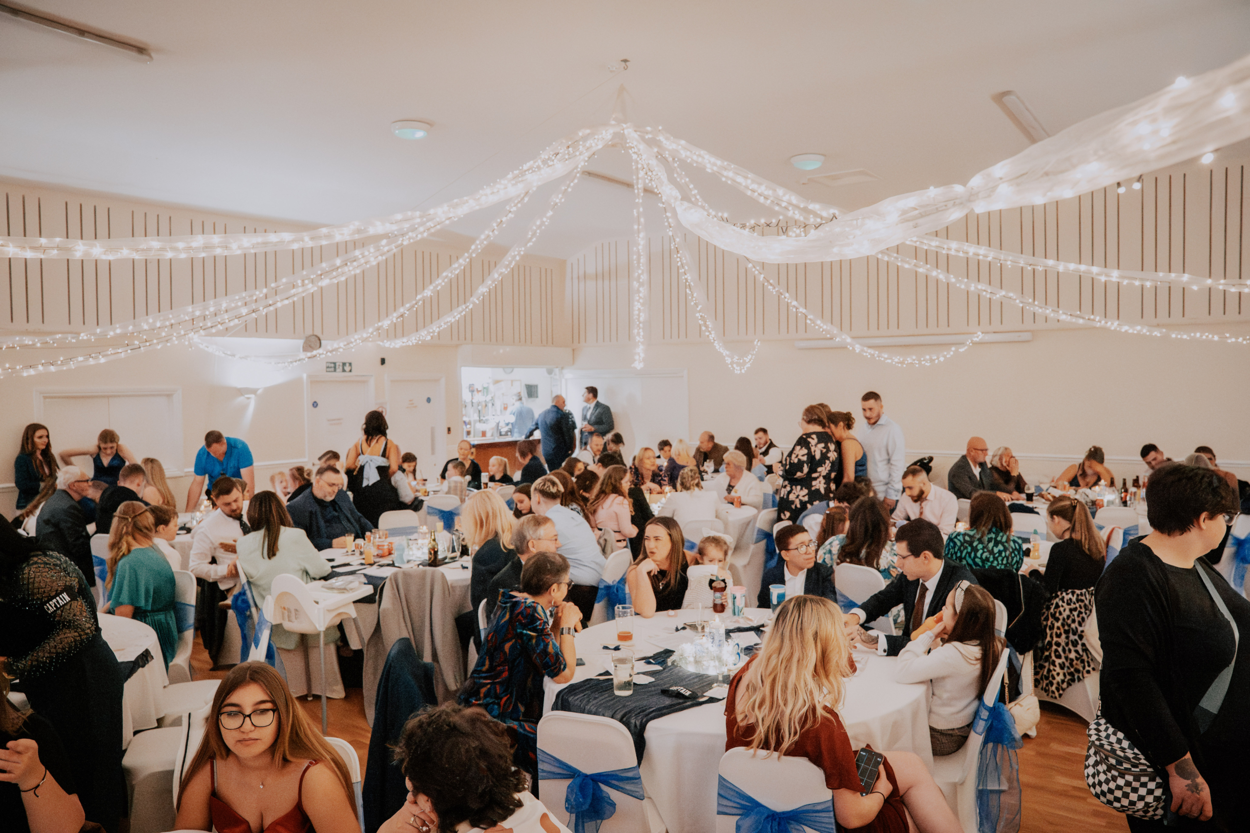 Wedding Videographer Southampton 3 Guests seated for the wedding breakfast beneath draped fairy lights