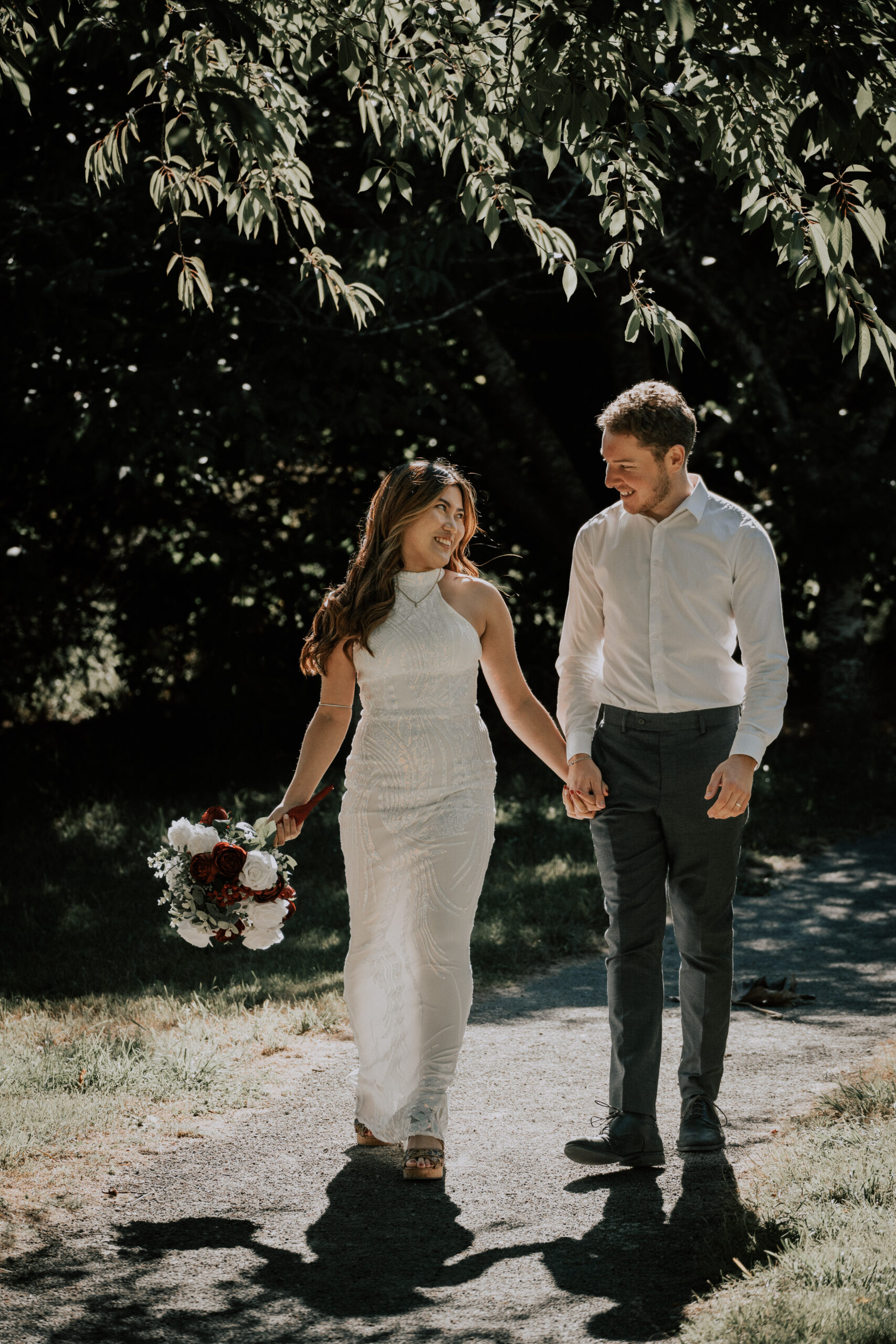 Couple walking hand in hand at dusk, a moment from wedding videography in Swanwick